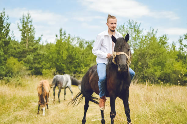 istock Young caucasian man ride horse. 993777180