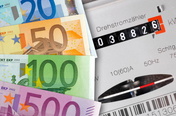 electric meter and Euro banknotes as symbol for high energy costs stock photo