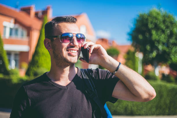 istock Man walking outside and talking on mobile phone. 993789474