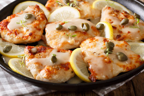 delicious chicken piccata with sauce and lemon on plate - caper sauce imagens e fotografias de stock