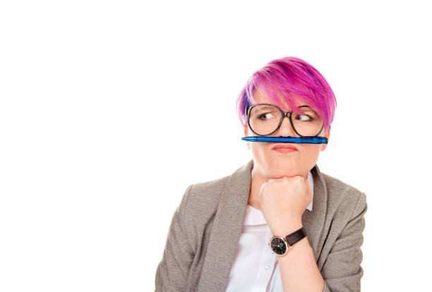 funny student corporate employee playing holding pen between nose and lips as mustache stock photo