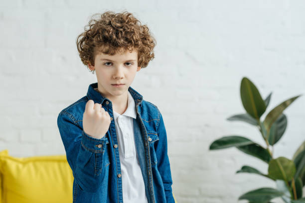istock Angry child boy showing clenched fist 993795678