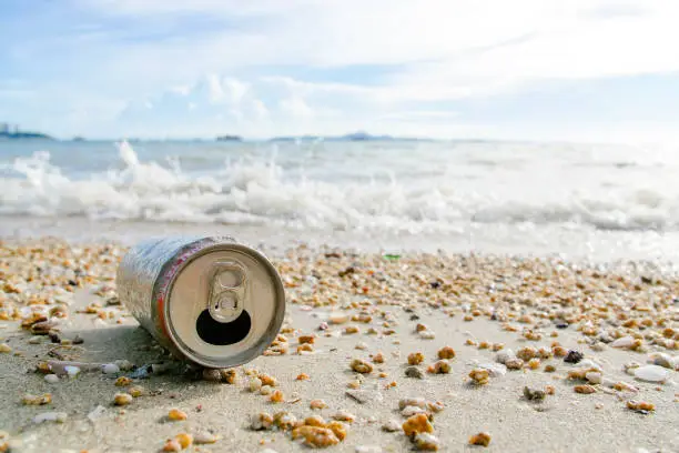 Photo of Garbage cola drinking cans on the beach