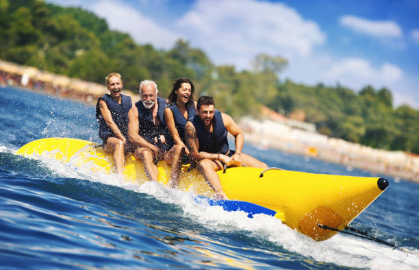 banana boat fun. - inflatable raft nautical vessel sea inflatable imagens e fotografias de stock