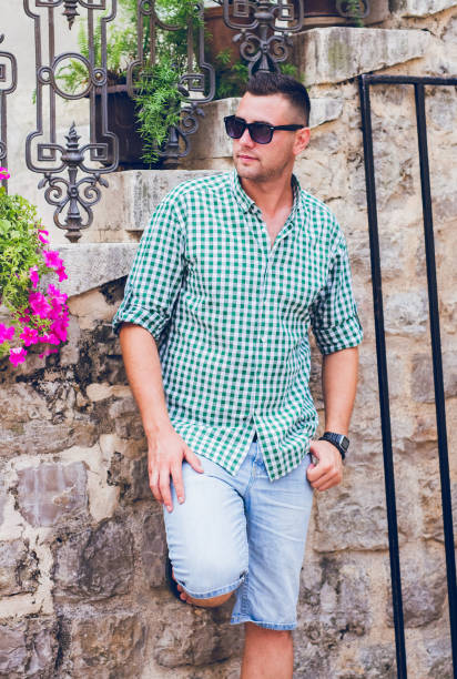 istock Man leaning on wall in Budva Montenegro old town. 993954680