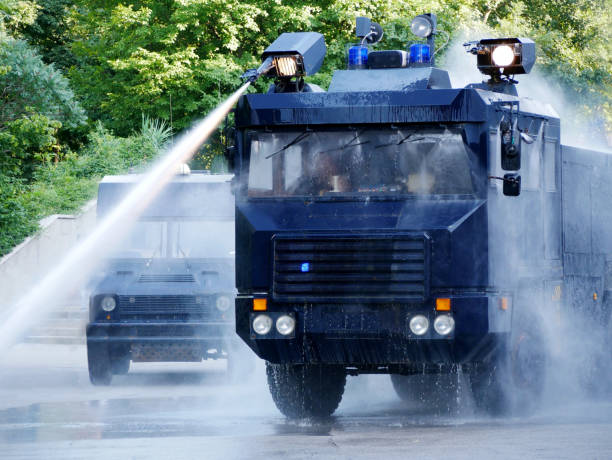 water cannon on a police truck - water cannon imagens e fotografias de stock
