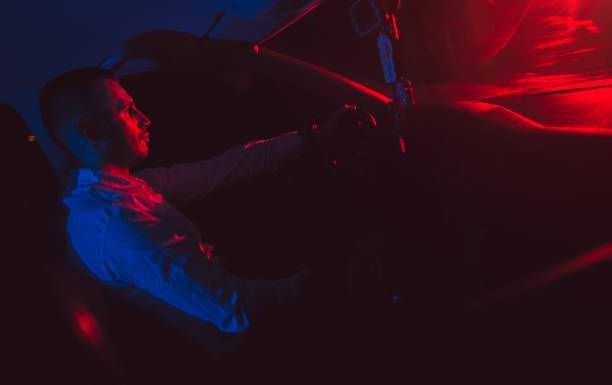 istock Man driving a car at night 993956044
