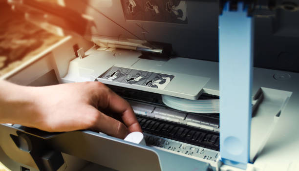 istock a man is repairing a printer. digital photocopier machine 993956086