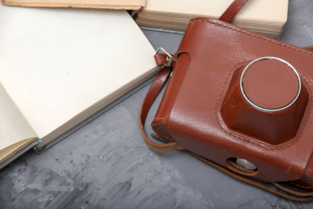 Vintage camera in the case and old open books