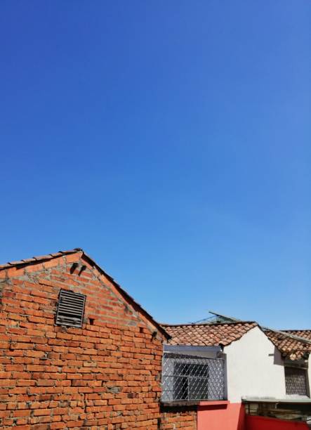 istock Brick houses with clay tiles and intense blue sky 993957090