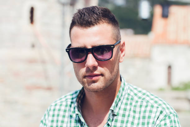 istock Man with sunglasses relaxin in old town Budva Montenegro. 993957162