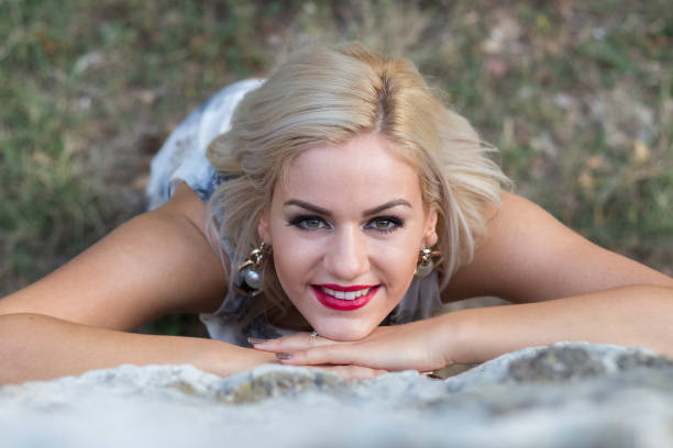 close up portrait of beautiful young adult caucasian woman in public park