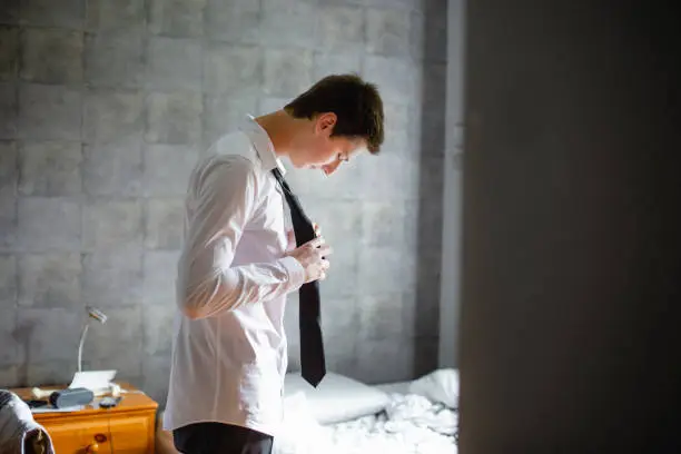 Photo of Teenage boy getting dress for an event