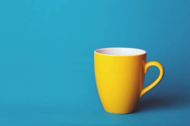 beautiful coffee yellow cup on blue background\
