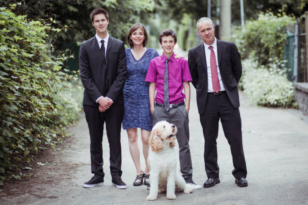 familien portrait - dog graduation hat school stock-fotos und bilder