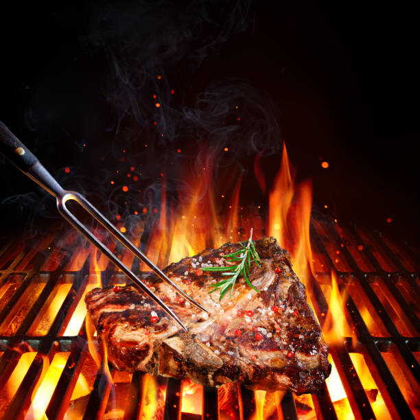Beefsteak On Barbecue Grill With Rosemary, Pepper And Salt Porterhouse On Grill With Flames t bone steak stock pictures, royalty-free photos & images