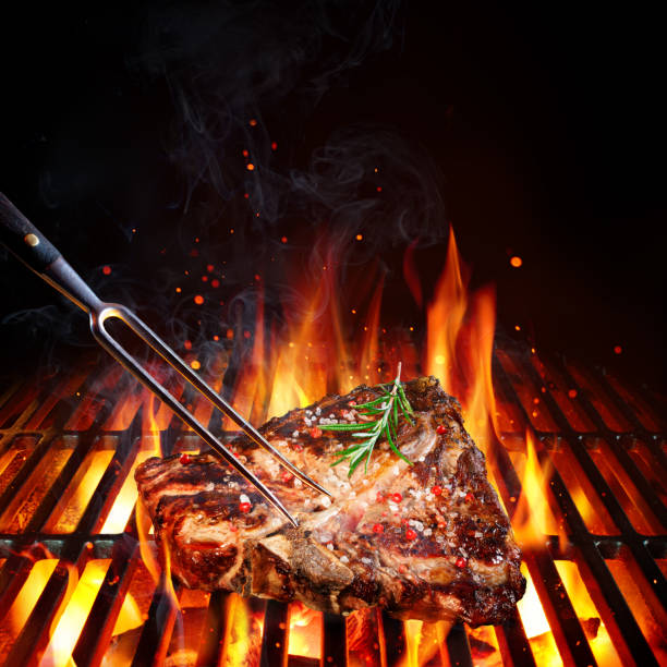 Beefsteak On Barbecue Grill With Rosemary, Pepper And Salt Porterhouse On Grill With Flames tuscan grill stock pictures, royalty-free photos & images