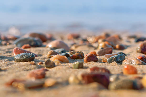 sea colored stones, rocky seashore, sea wave and pebbles
