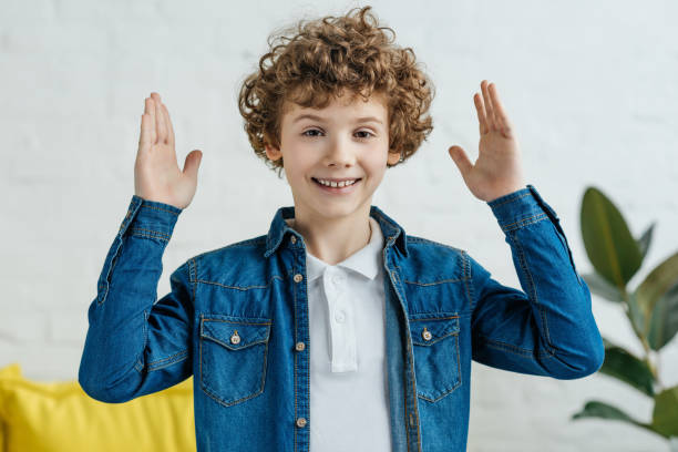 istock Smiling little child holding hands up 993964430