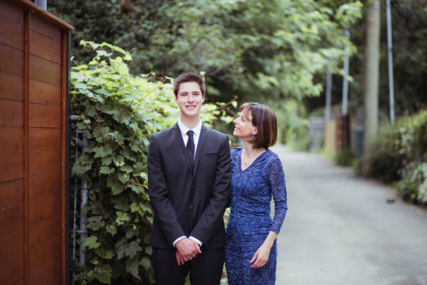 Portrait of mother and son for prom night adult, teenage boy, well dressed, suit, celebration event, prom prom photos stock pictures, royalty-free photos & images