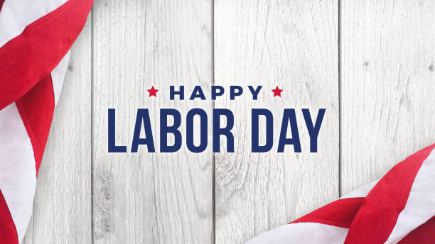 istock Happy Labor Day Text Over White Wood and American Flags 993965402