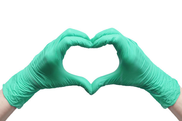 Heart made of green medical gloves stock photo