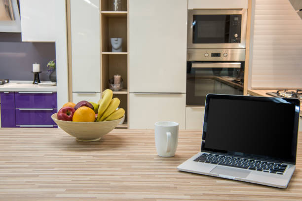 istock cozy modern kitchen interior with laptop and fruits in bowl 993966186