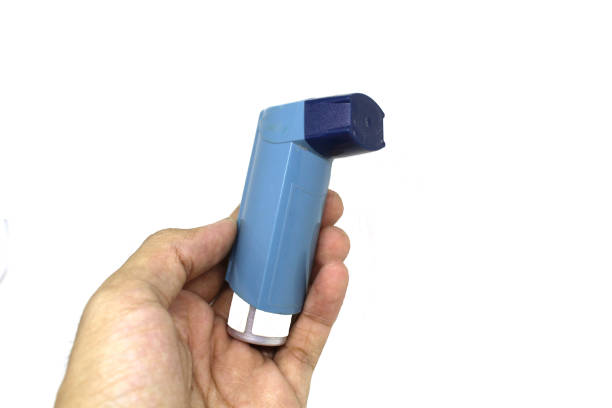 istock hand holding asthma inhaler in white background 993967552