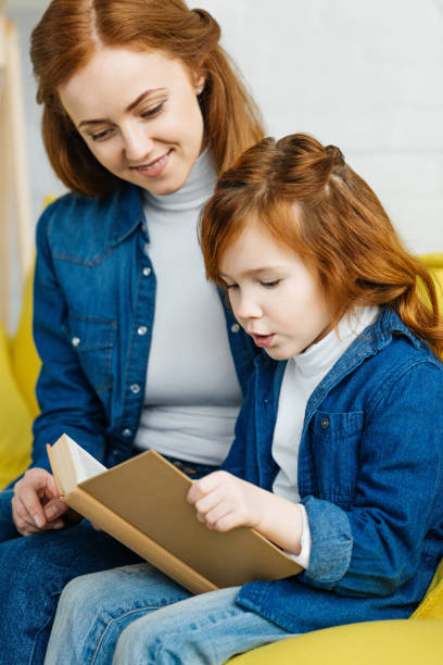 istock Mother and daughter reading book together 993968634