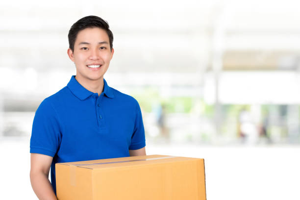 130+ Smiling Handsome Asian Delivery Man Giving And Carrying Parcel Stock  Photos, Pictures & Royalty-Free Images - iStock