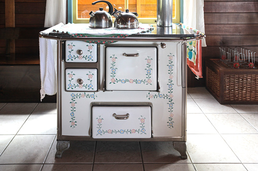The vintage stove is for cooking, heating the environment and water.
