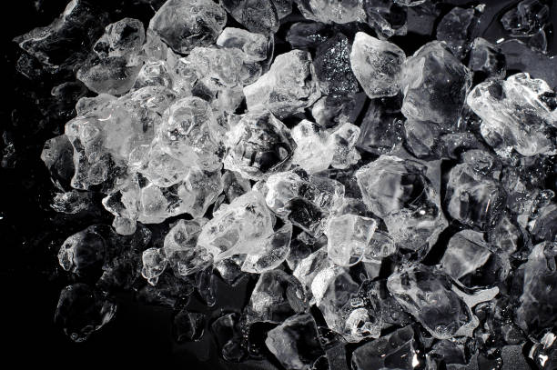 istock Textured background of a small ice cubes on the black background 993981418