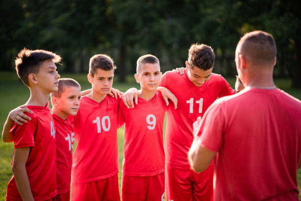 istock Back view coach talking to his soccer team before game 993982042