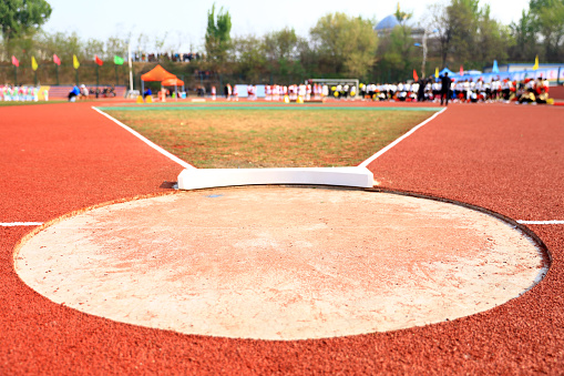 A shot of a single hurdle standing on an outdoor running track.