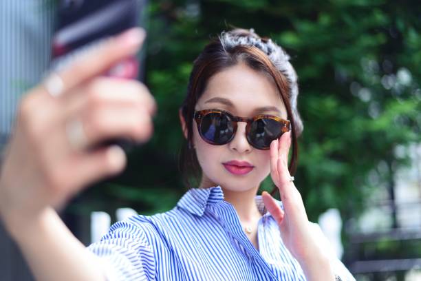 Young woman taking selfie outside