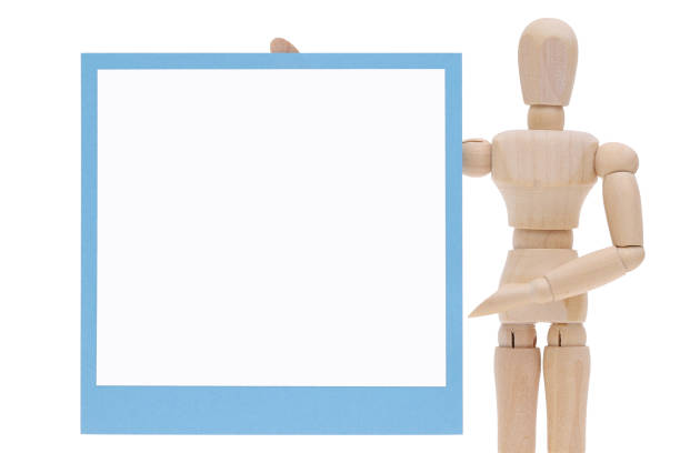 istock Wooden dummy with blank instant photo 994009324