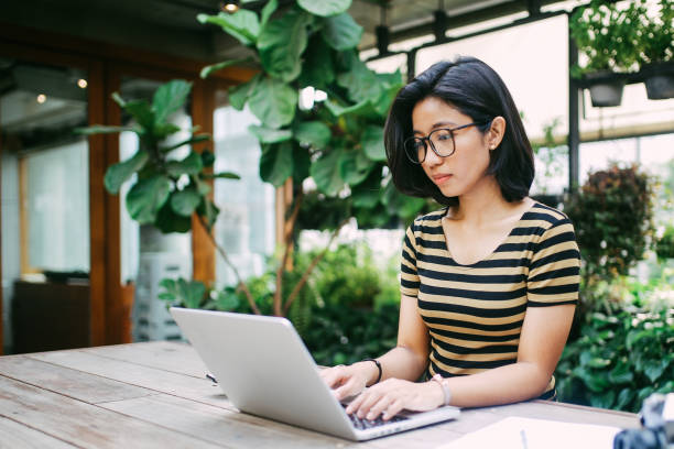istock Young Asian freelancer woman finishing up with work 994011686