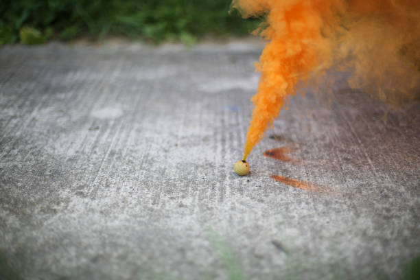 istock Smoke Bomb on a Sidewalk Surrounded by Grass 994014364