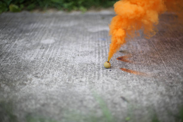 istock Smoke Bomb on a Sidewalk Surrounded by Grass 994016392