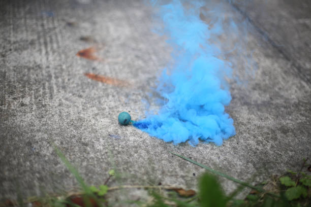 istock Smoke Bomb on a Sidewalk Surrounded by Grass 994016512