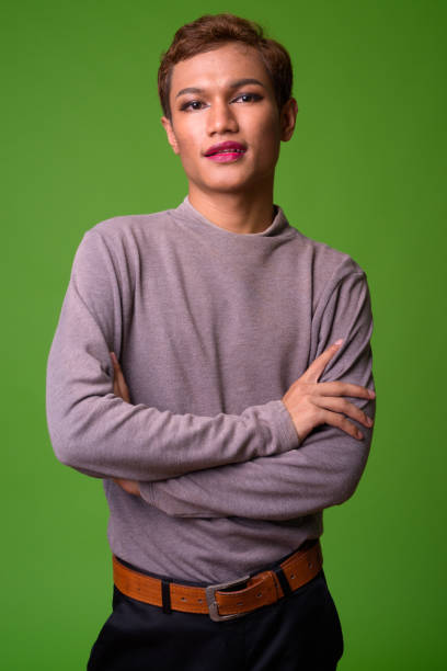 Androgynous young Asian man wearing makeup Studio shot of androgynous young Asian man wearing makeup gay long hair stock pictures, royalty-free photos & images
