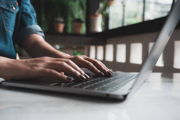istock Closeup image of a woman's hands working and typing on laptop keyboard on table 994020544