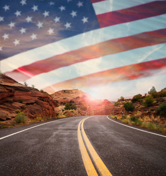 istock Empty road and american flag in sky 994036780
