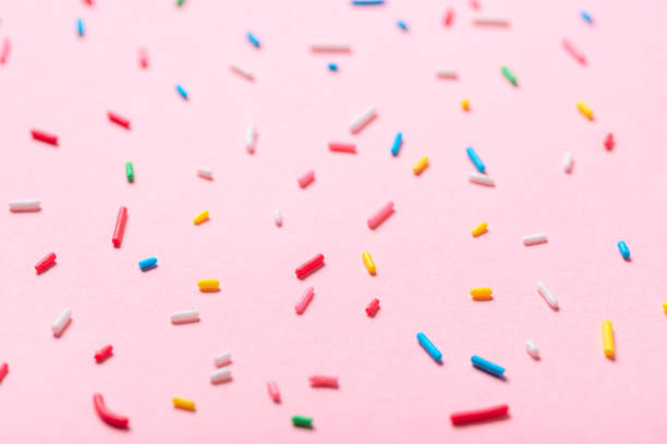 istock sugar colorful sprinkles over pink background 994050284