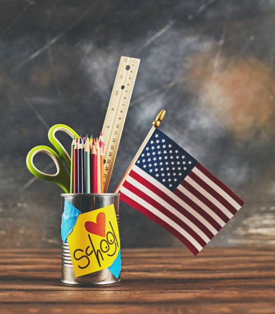 istock Back to school supplies in tin can against worn chalkboard 994054606