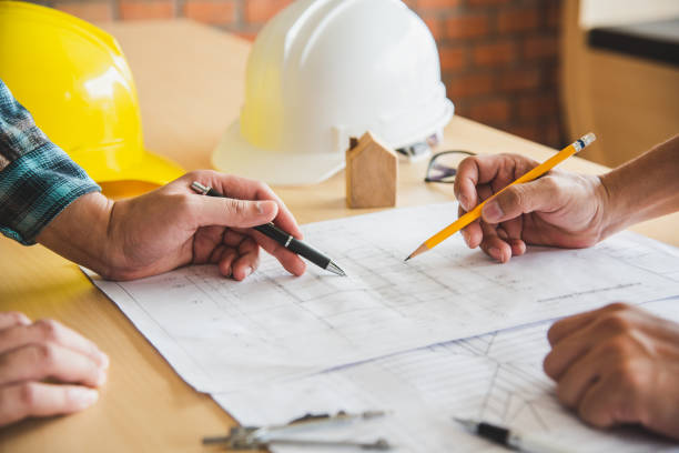 istock Engineering teams are meeting to present and discuss construction work designed and implemented. 994059792