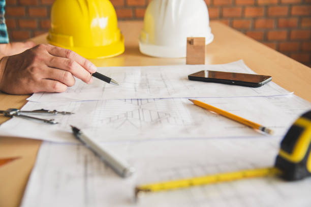 istock engineer working in office with blueprints, inspection in workplace for architectural plan, construction project ,Business construction concept. 994059886