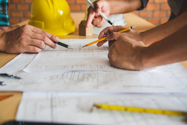 istock Engineering teams are meeting to present and discuss construction work designed and implemented. 994059904