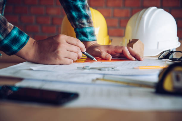 istock engineer working in office with blueprints, inspection in workplace for architectural plan, construction project ,Business construction concept. 994060070