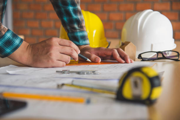istock engineer working in office with blueprints, inspection in workplace for architectural plan, construction project ,Business construction concept. 994060132